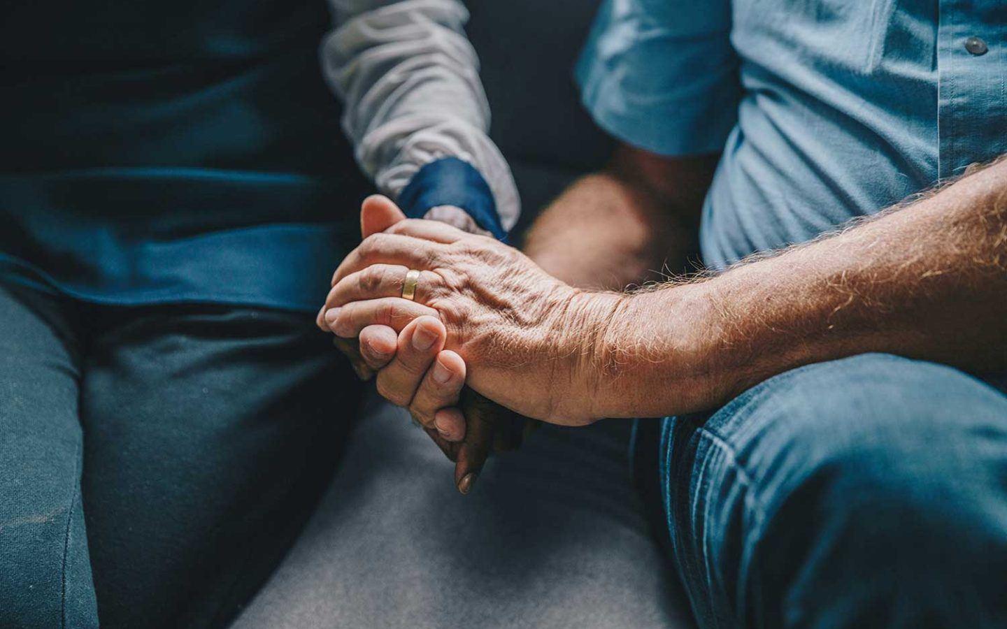 senior couple holding hands