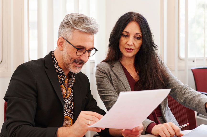 man and woman reviewing document